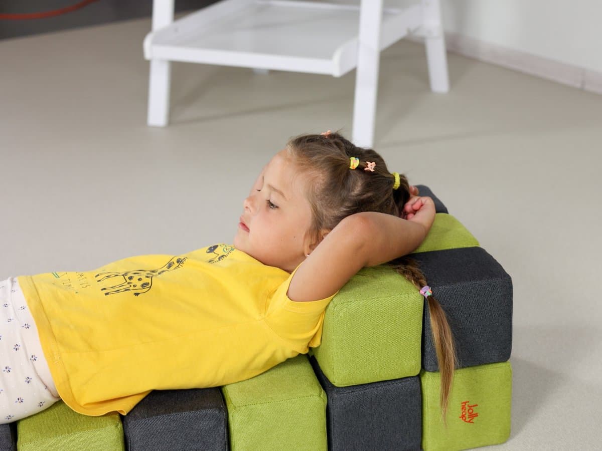 A girl resting against soft blocks